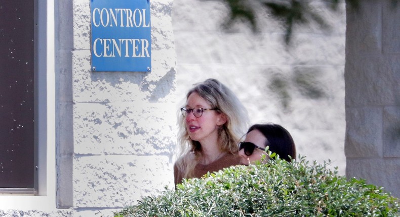 Disgraced Theranos CEO Elizabeth Holmes, left, is escorted by prison officials into a federal womens prison camp on Tuesday, May 30, 2023, in Bryan, Texas.Michael Wyke/Associated Press