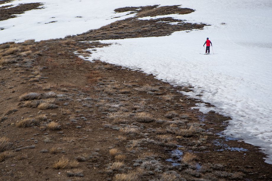 A skier approaches the edge of the snow at Lake Tahoe in March.