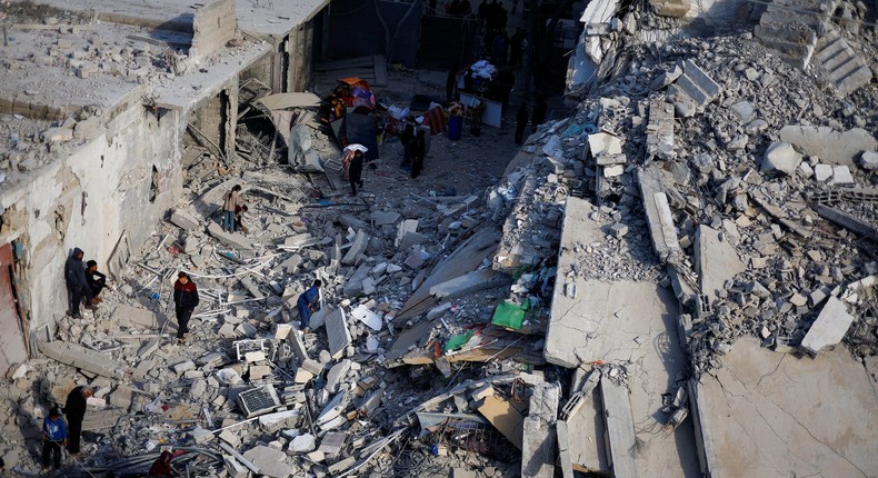 Palestinians inspect the site of an Israeli air strike on a building in Rafah on March 9, 2024.Mohammed Salem/Reuters