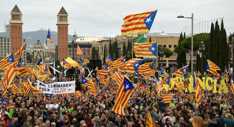 Pro-independence demonstrators hold flags during a demonstration in Barcelona on November 13, 2016 against Spain's use of the courts to stop Catalonia's pro-independence aspirations