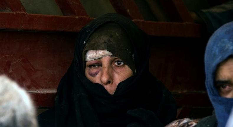 An Iraqi woman, who has fled fighting between government forces and the last jihadists in Mosul's Old City, awaits to be relocated on July 8, 2017