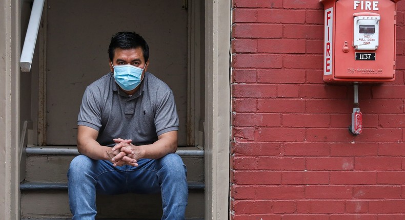 Fredy Sanan sits on the steps leading up to his first-floor Chelsea, MA apartment on May 8, 2020.