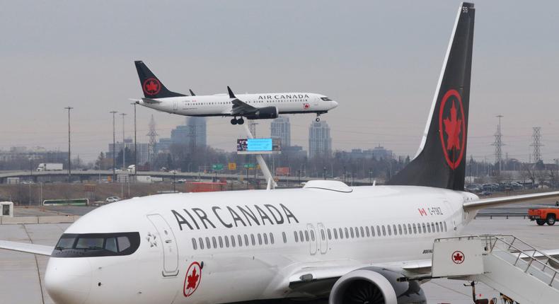 FILE PHOTO: An Air Canada Boeing 737 MAX 8 from San Francisco approaches for landing at Toronto Pearson International Airport over a parked Air Canada Boeing 737 MAX 8 aircraft in Toronto