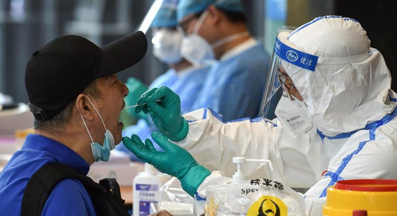 A man, who visited Beijing recently, is tested for the COVID-19 coronavirus in Nanjing in China's eastern Jiangsu province on June 15, 2020. - China's capital city raced on June 15 to control a fresh coronavirus outbreak, with 75 cases linked to a single wholesale food market in Beijing where authorities have locked down neighbourhoods and launched a massive test and trace programme. (Photo by STR / AFP) / China OUT (Photo by STR/AFP via Getty Images)