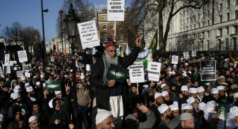 Muslim demonstrators hold placards during a protest against the publication of cartoons depicting the Prophet Mohammad in French satirical weekly Charlie Hebdo, near Downing Street in central London 