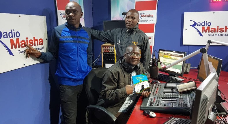 Hassan Ali Kauleni (seated) posing with Nuru Ya Lugha panelists.