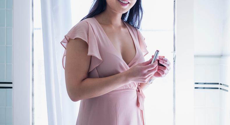 Illustrative photo of a woman wearing a pink dress.Tony Anderson/Getty Images