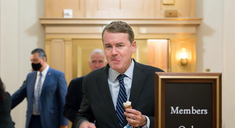 Democratic Sen. Michael Bennet of Colorado eats an ice cream cone while walking in the halls of the US Capitol during the budget resolution proceedings on August 10, 2021 in Washington, DC.Liz Lynch/Getty Images