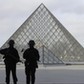 French police secure the site near the Louvre Pyramid in Paris