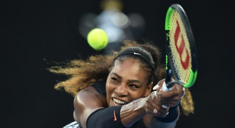 Serena Williams of the US hits a return against Venus Williams of the US during the women's singles final on day 13 of the Australian Open tennis tournament in Melbourne on January 28, 2017