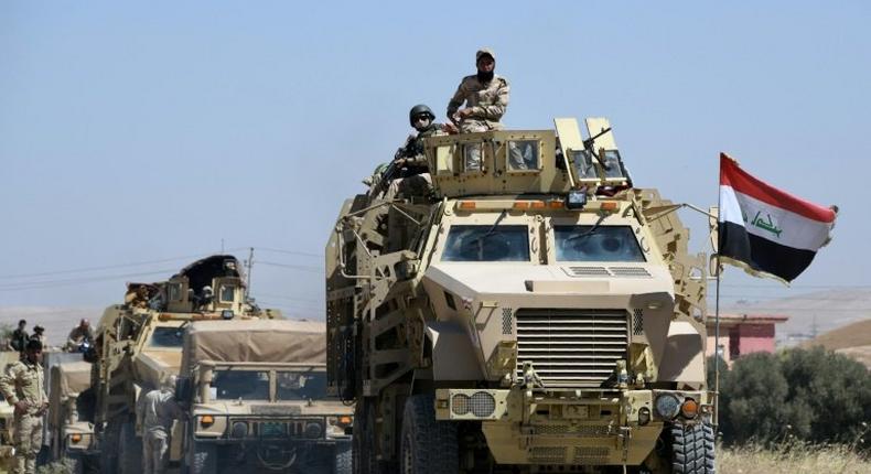 Iraqi government forces drive down a road leading to Tal Afar on June 9, 2017, before the official start of the assault to retake the town from the Islamic State group