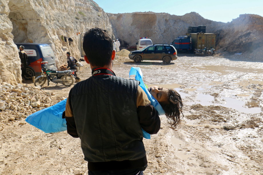 A man carries the body of a dead child, after what rescue workers described as a suspected gas attack in the town of Khan Sheikhoun in rebel-held Idlib, Syria, April 4, 2017.