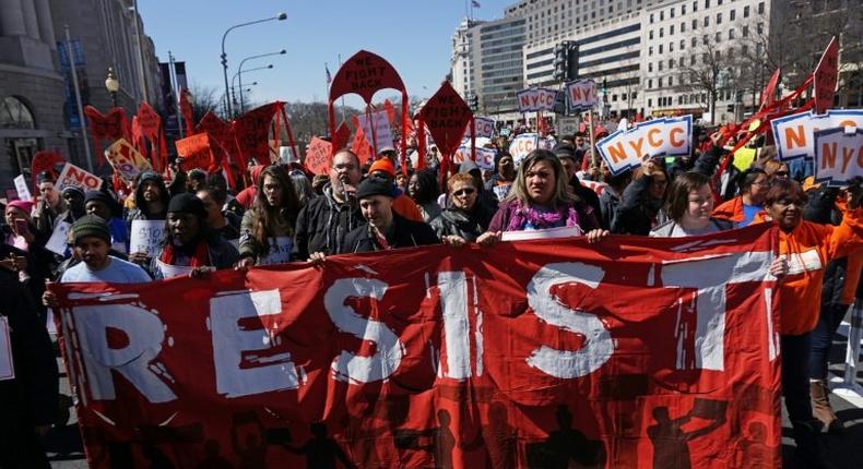 Health care activists march to the Trump International hotel in Washington, DC, during a protest against President Donald Trump's effort to repeal Obamacare