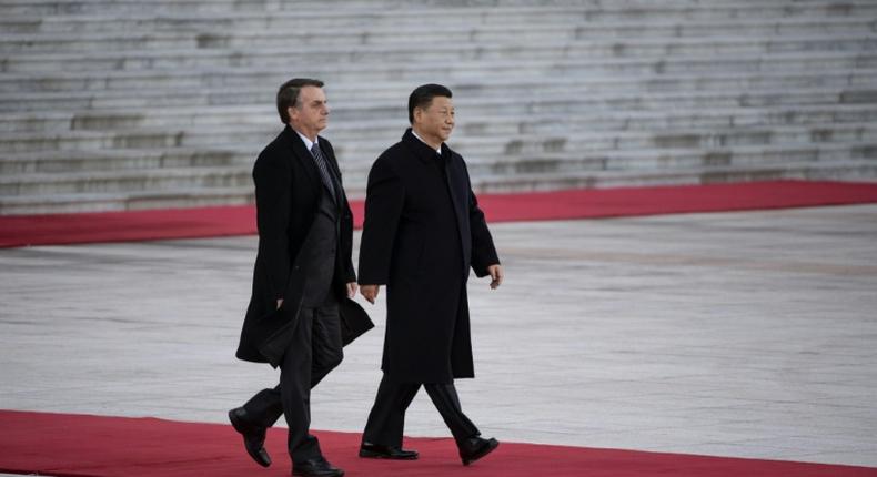 President Jair Bolsonaro (L) will walk a diplomatic tightrope as he hosts his Chinese counterpart Xi Jinping (R) in Brazil