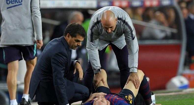 Lionel Messi receives attention after injuring his arm on Saturday