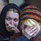 Women mourn during commemoration ceremony at the Dubrovka Theatre in Moscow