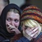 Women mourn during commemoration ceremony at the Dubrovka Theatre in Moscow