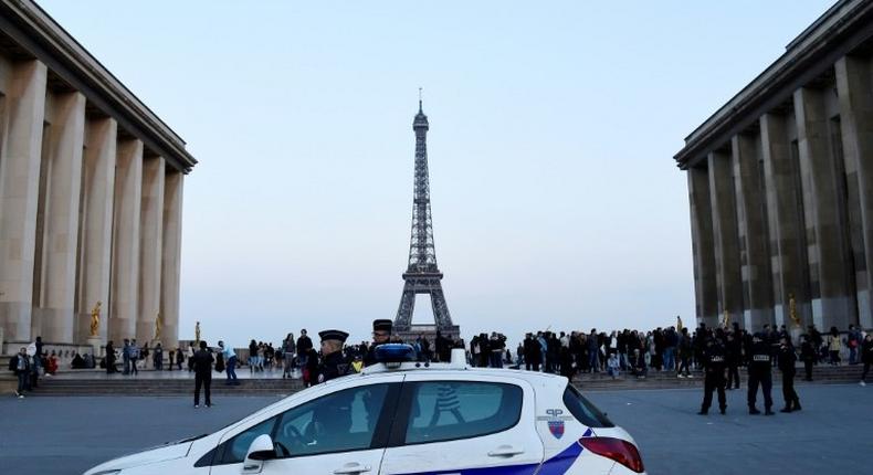 Candidates in the French presidential election have clashed over how to protect France since a policeman was shot dead in Paris