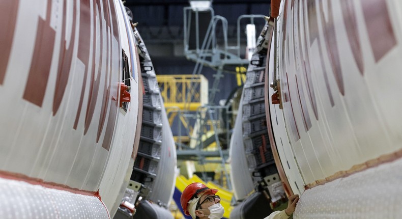 An employee prepares a Proton-M heavy-lift launch vehicle, part of the ExoMars mission.