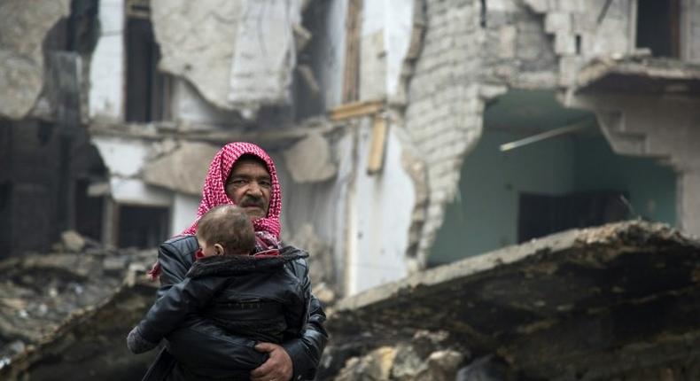 Syrians leave a rebel-held area of Aleppo towards the government-held side during an operation by Syrian government forces to retake the embattled city