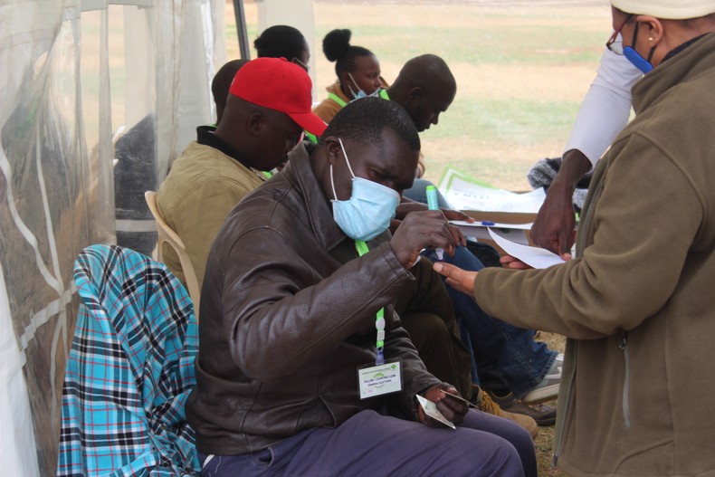 An IEBC official applies ink on a voters' pinky finger as an indication that she took part in the voting process in South C ward, Lang'ata constituency (Photo by Cyprian Kimutai Limo)