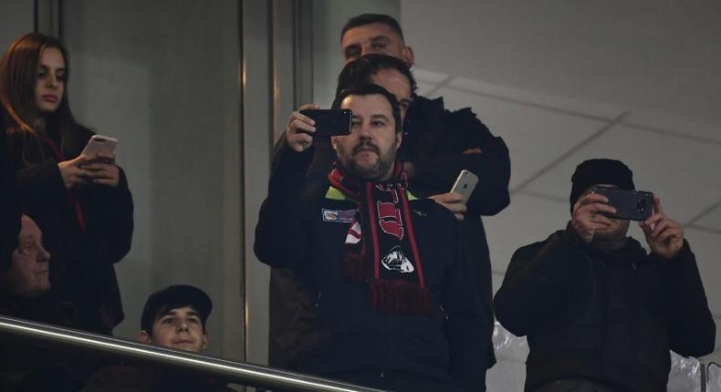 Italy's Interior Minister and Deputy Prime Minister Matteo Salvini (C) is a passionate AC Milan fan.