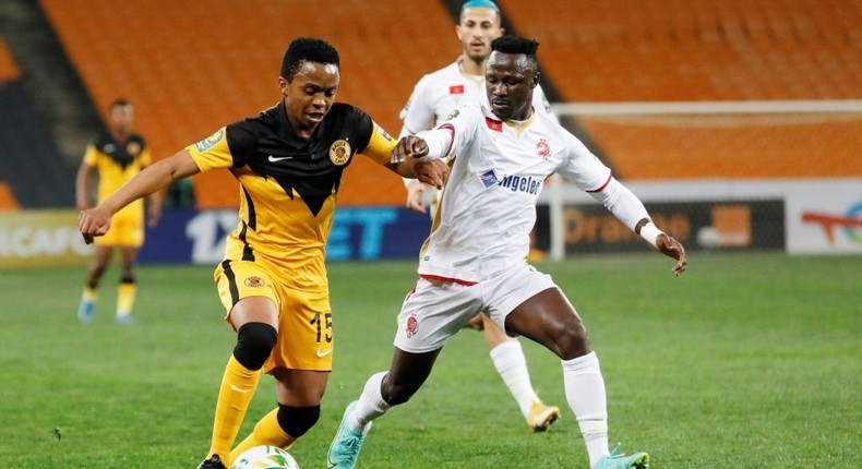 Simon Msuva (R) of Wydad Casablanca pursues  Nkosingiphile Ngcobo (L) of Kaizer Chiefs during a CAF Champions League semi-final second leg at Soccer City stadium in Johannesburg on Saturday. Creator: Phill Magakoe