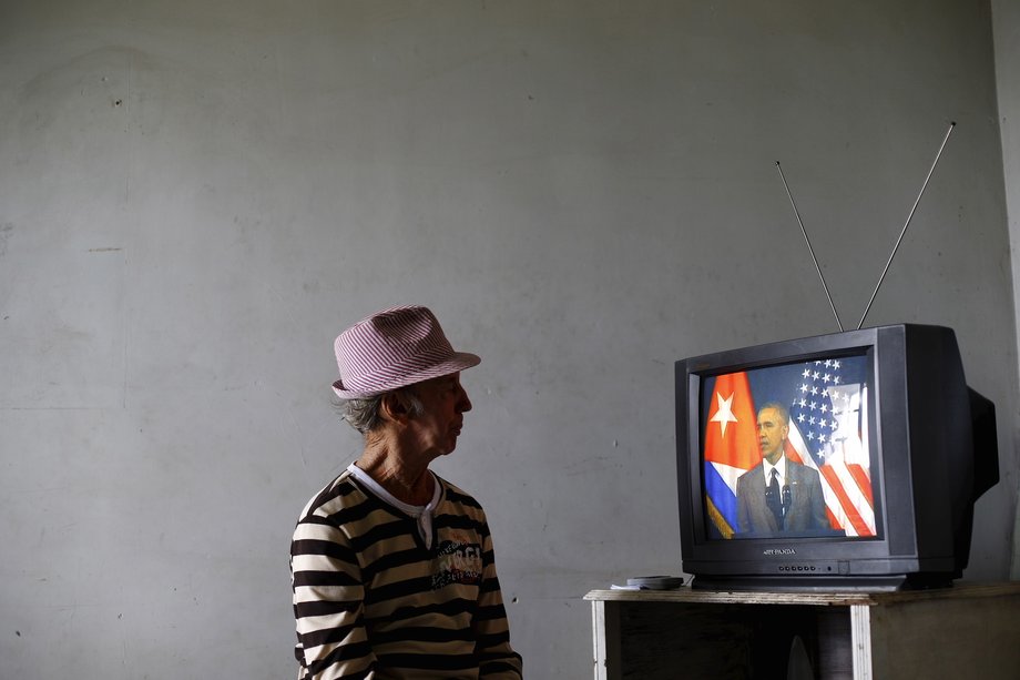 A man watches then US President Barack Obama speak at the Gran Teatro de la Habana Alicia Alonso in Havana, March 22, 2016.