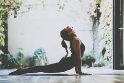 Portrait of gorgeous young woman practicing yoga indoor. Beautiful girl