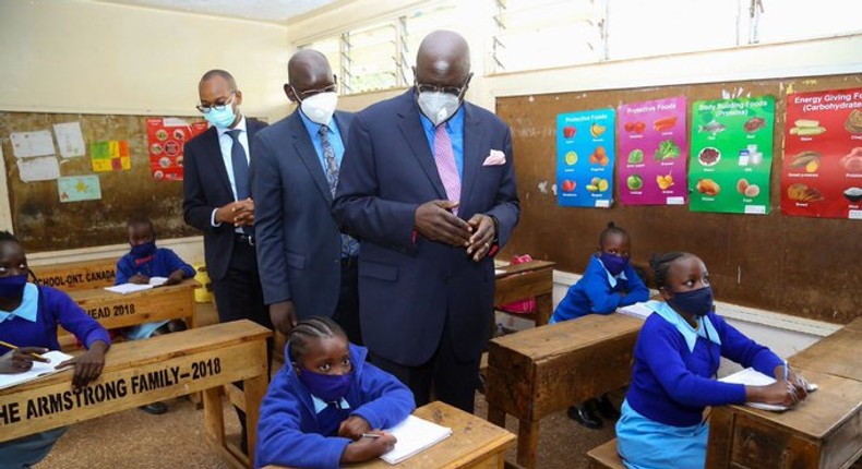 Education CS George Magoha with PS Belio Kipsang at the Olympic Primary School on day 1 of school re-opening following the Covid-19 break