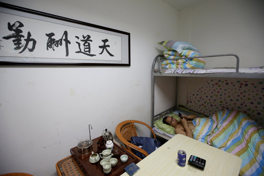 Dormitories like this one are provided in the DouMiYouPi office. Here, an IT engineer rests after finishing work at midnight. According to Reuters, the writing on the wall translates as "God rewards the diligent."