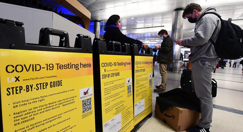 A man checks in at a COVID-19 testing site in the international arrivals area of Los Angeles International AirportFREDERIC J. BROWN/AFP via Getty Images