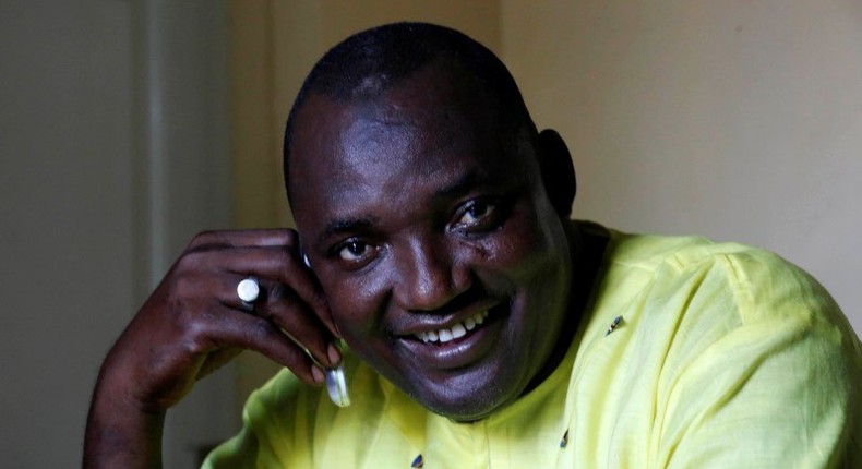 The new president of Gambia, Adama Barrow smiles as he makes a call at his home in Yarambamba, West Coast Region, Gambia December 3, 2016. REUTERS/ Thierry Gouegnon