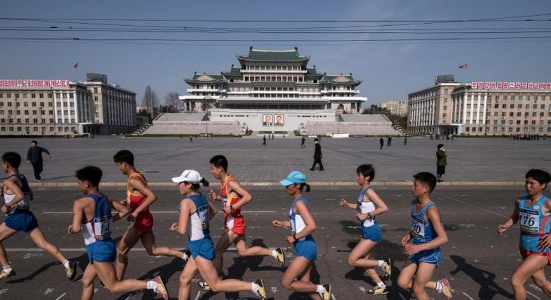 Competitors run through Kim Il-Sung square during the Pyongyang Marathon, on April 9, 2017