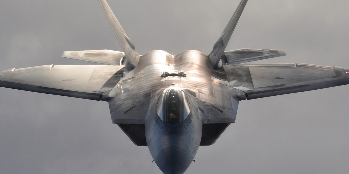 A US Air Force F-22 Raptor fighter aircraft flies over Alaskan terrain after refueling, January 5, 2013.