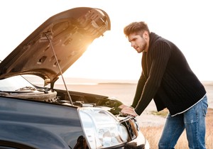 graphicstock-young-upset-casual-man-trying-to-fix-his-broken-car-outdoors Sdv 0 Ing
