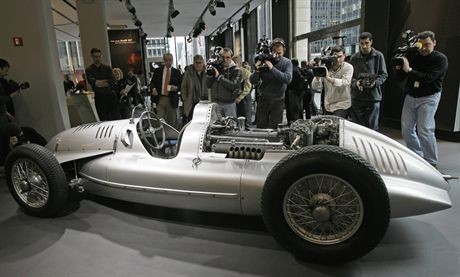 Cameramen gather around one of the 1930's silver arrow cars, a fabled 1939 Auto Union D-type racing vehicle, said to be one of the most important cars in motor racing history, at an Audi of America dealer on Park Avenue in New York Thursday, Jan. 25, 2007, during a public viewing before the car is auctioned off at Retromobile February 17 in Paris. Christie's, who is bringing the car to auction, is expecting bids in the region of $12 to $15 million for the car. The Auto Union's revolutionary design, conceived by Ferdinand Porsche, place the driver in front of the engine and fuel tanks, with all four wheels benefiting from independent suspension. Only five of the final model D-type Auto Unions remain, and this car is the only privately-owned model. (AP Photo/Kathy Willens)