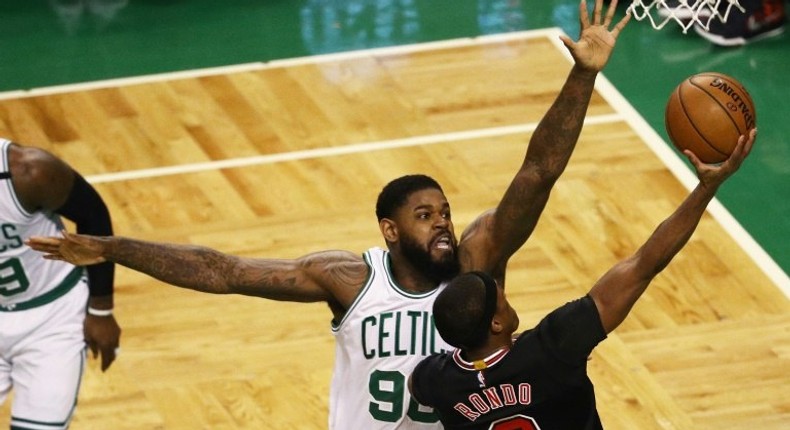 Amir Johnson of the Boston Celtics defends a shot by Rajon Rondo of the Chicago Bulls in Game Two of the Eastern Conference quarter-finals, at TD Garden in Boston, Massachusetts, on April 18, 2017