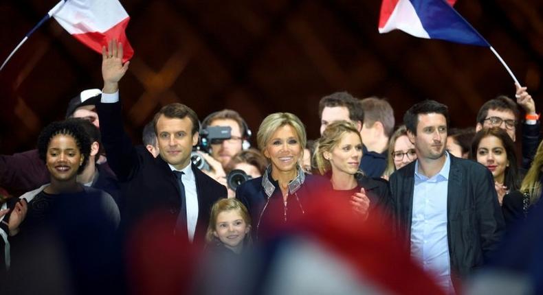 Emmanuel Macron with his wife Brigitte and members of her family at a victory party after his resounding win over far-right rival Marine Le Pen