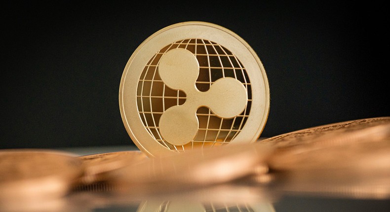 A ripple coin stands on a table