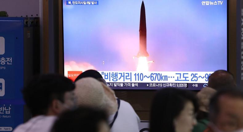 People watch a TV broadcast about a North Korean missile launch at the Seoul Railway Station, June 5, 2022.