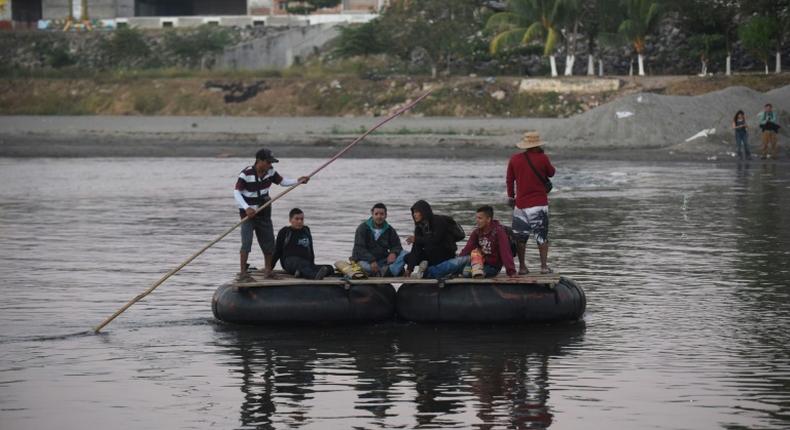 Honduran migrants heading to the United States in a caravan cross the Suchiate River, the natural border between Guatemala and Mexico, in makeshift rafts without waiting for humanitarian visas offered by Mexico