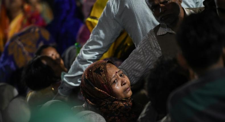 A relative of Rahul Thakur, 23, who died in this week's sectarian riots in India's capital, mourns before his cremation