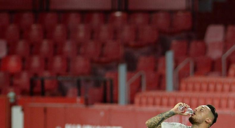 Thirsty work: Sevilla's Argentinian midfielder Lucas Ocampos drinks water during the game with Mallorca