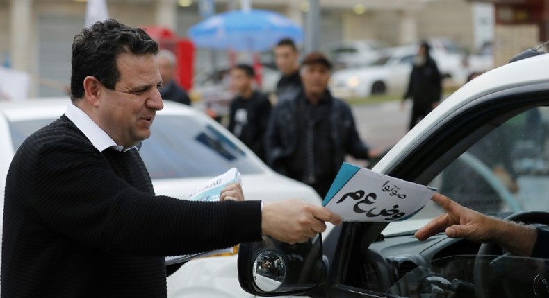 Leading Israeli Arab politician Ayman Odeh hands out leaflets while campaigning for Tuesday's general election