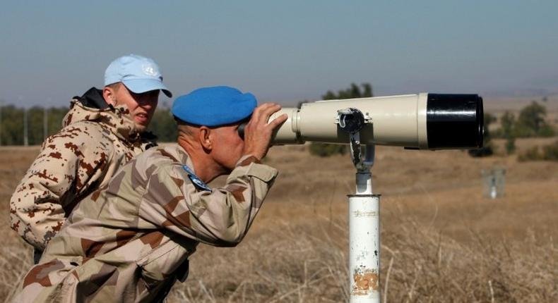 A UN officer monitors the Israel-Syria border in the Israeli-annexed Golan Heights, on November 27, 2016