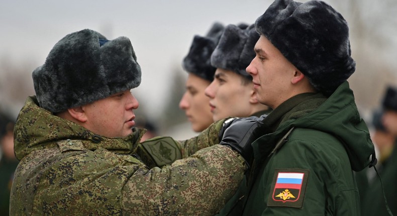 A Russian serviceman adjusts the uniform of a conscript at a gathering point in Omsk on November 10, 2022.REUTERS/Alexey Malgavko