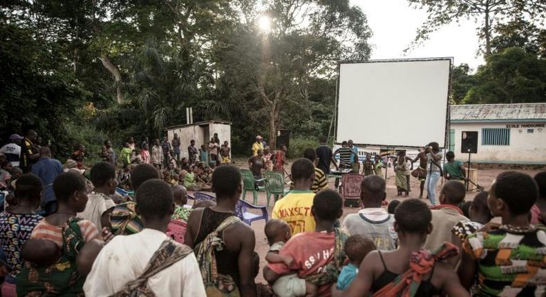 Many residents of a village of the Mbyaka (Pygmy) people gather in Bayanga after a trek for the cinema night