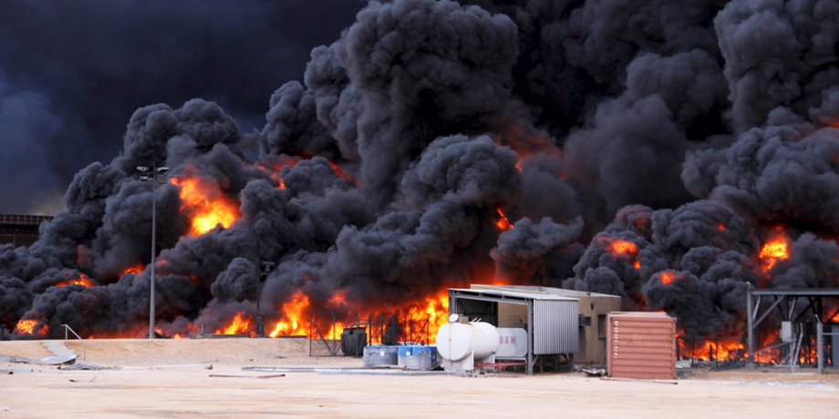 Smoke rises from burning oil storage tanks in the port of Ras Lanuf, Libya, January 23, 2016.