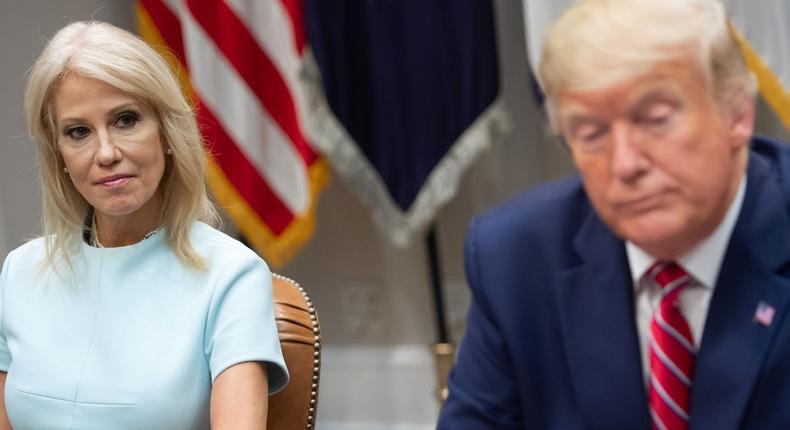 Kellyanne Conway and Donald Trump listen during a White House meeting on the opioid epidemic in 2019.